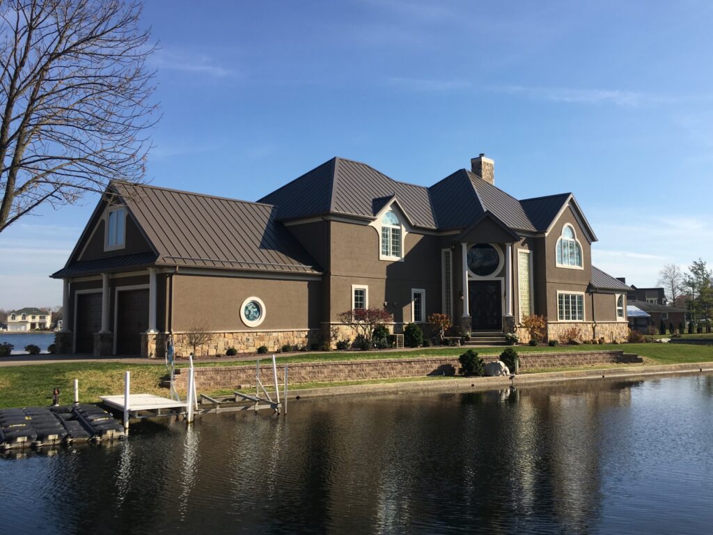 Picture of a home with metal roofing on a lake