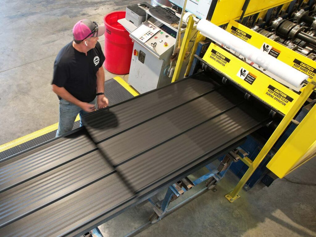 Man manufacturing metal siding