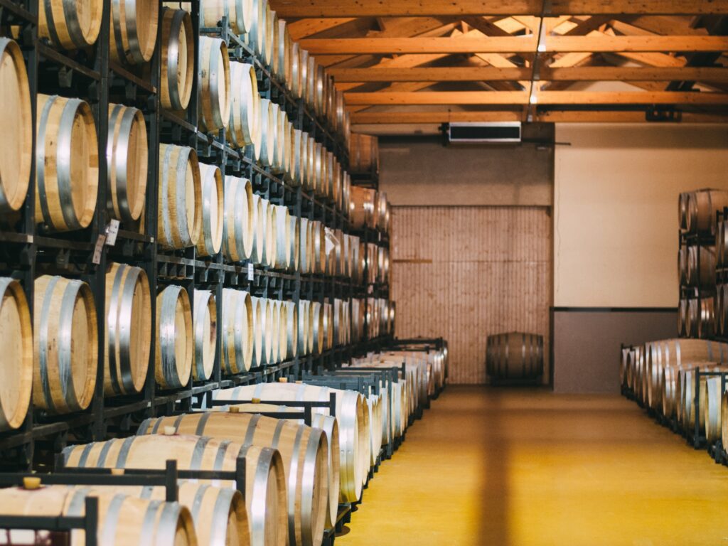 Wood wine barrels stored in a winery on the fermentation process