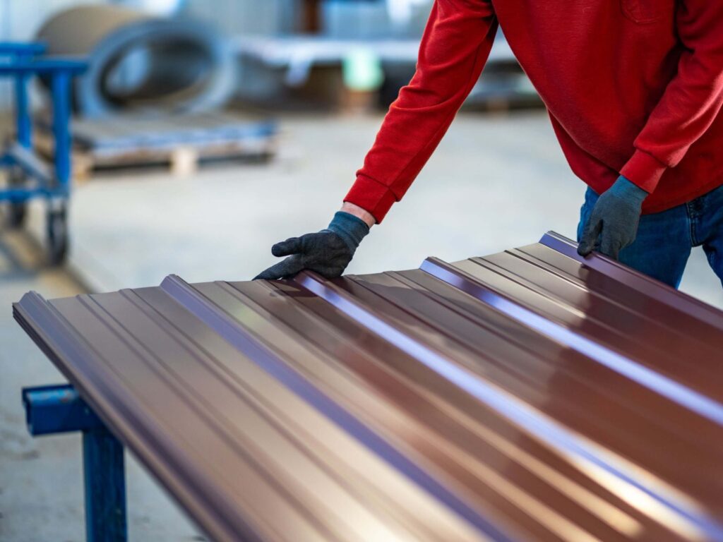 A man holding a metal panel