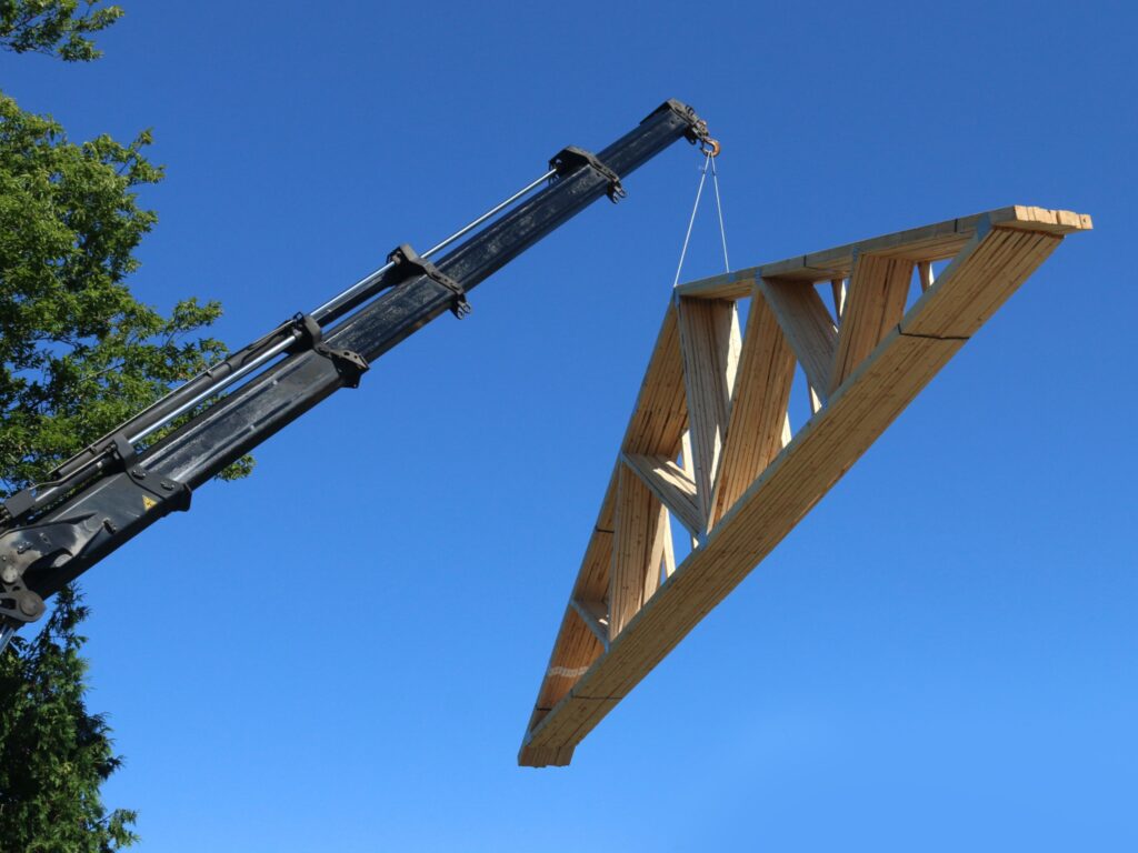 Trusses being lifted by a crane.