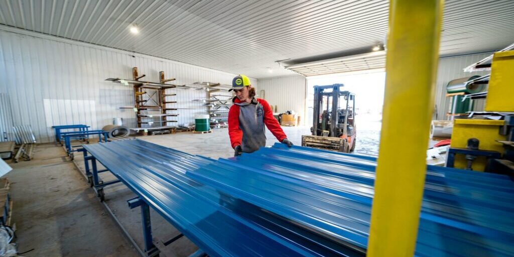 Man working with metal in a warehouse